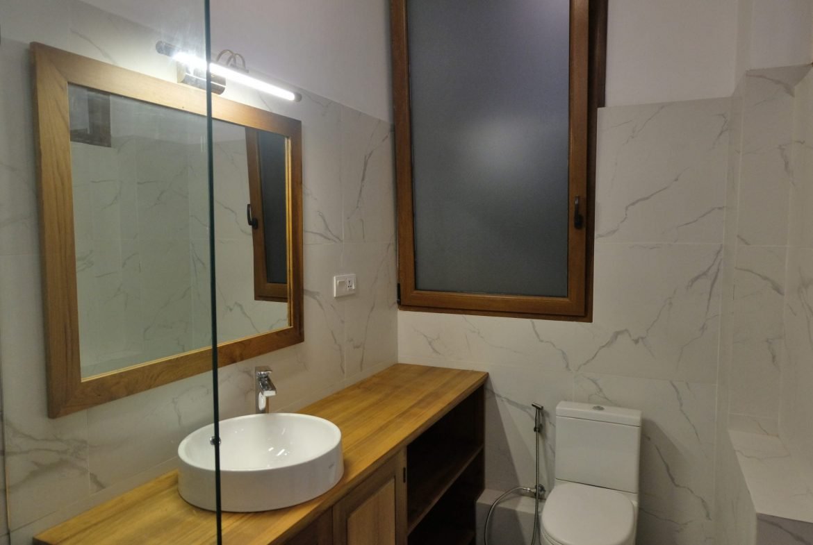guest bathroom with mirror
