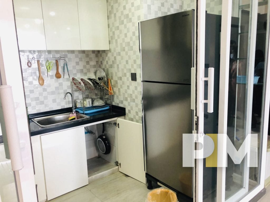 kitchen with fridge freezer in yangon apartment for rent