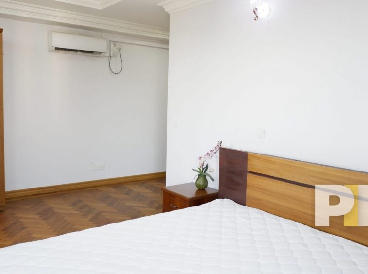 bedroom with wardrobes and side table - properties in yangon