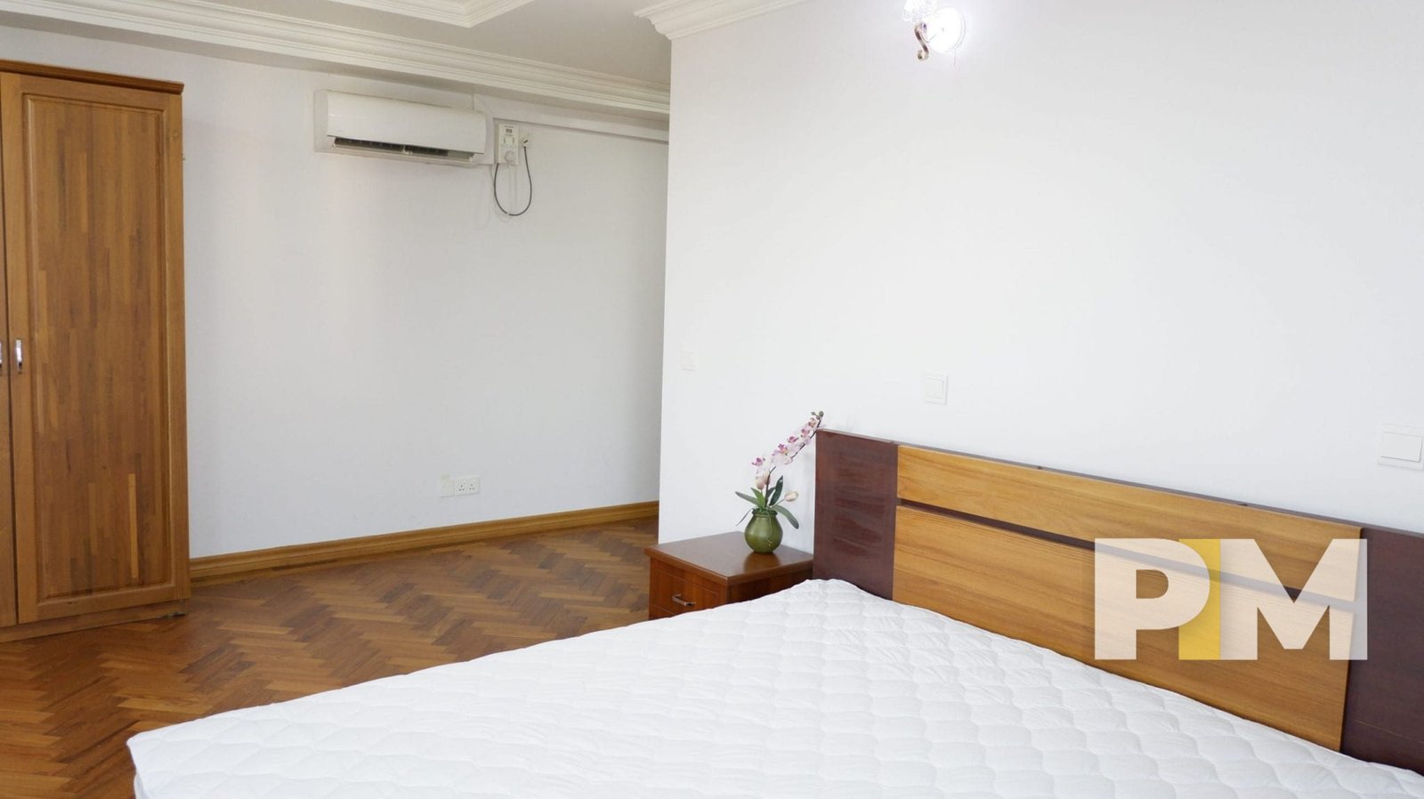 bedroom with wardrobes and side table - properties in yangon