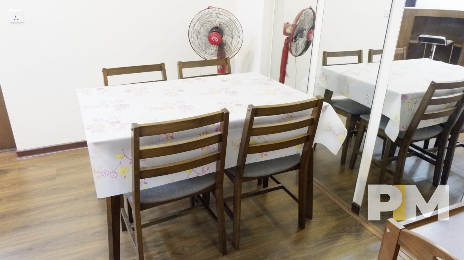 dining table and chairs with a fan - yangon real estate