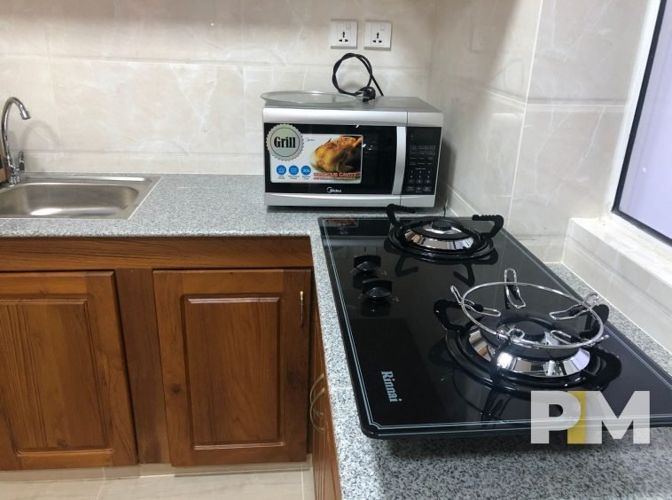 gas stove and microwave in apartment for rent in myanmar