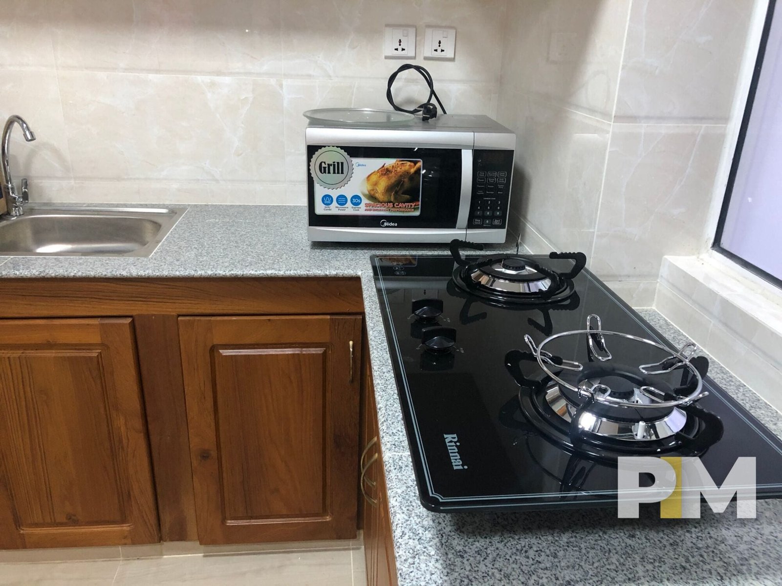 gas stove and microwave in apartment for rent in myanmar