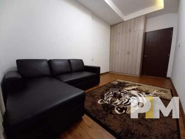 living room with sofa and rug - apartments for rent in myanmar