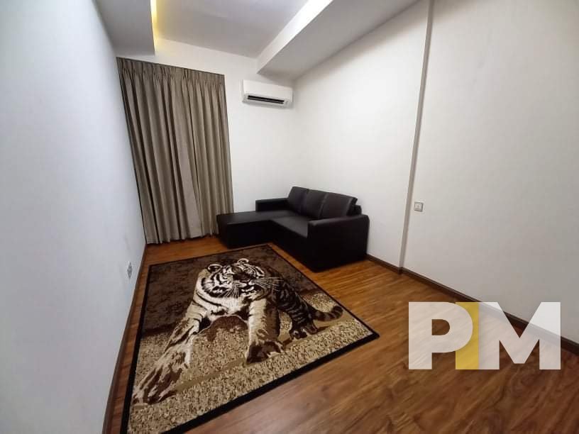 private living room with tiger rug - real estate in myanmar