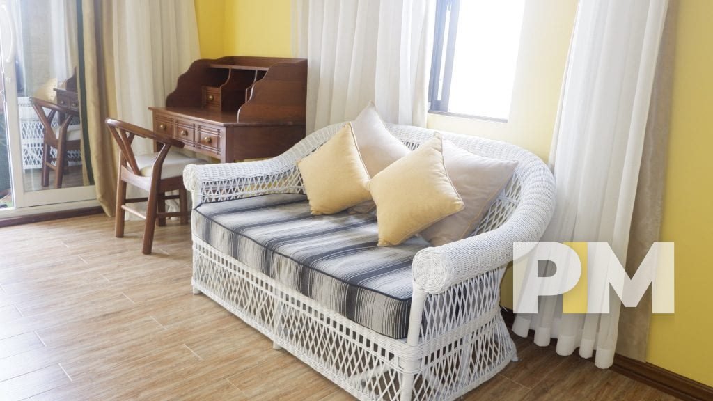 rattan chair in apartment for rent in yangon