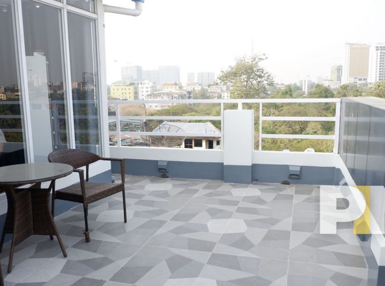 terrace with table and chairs in yangon apartment