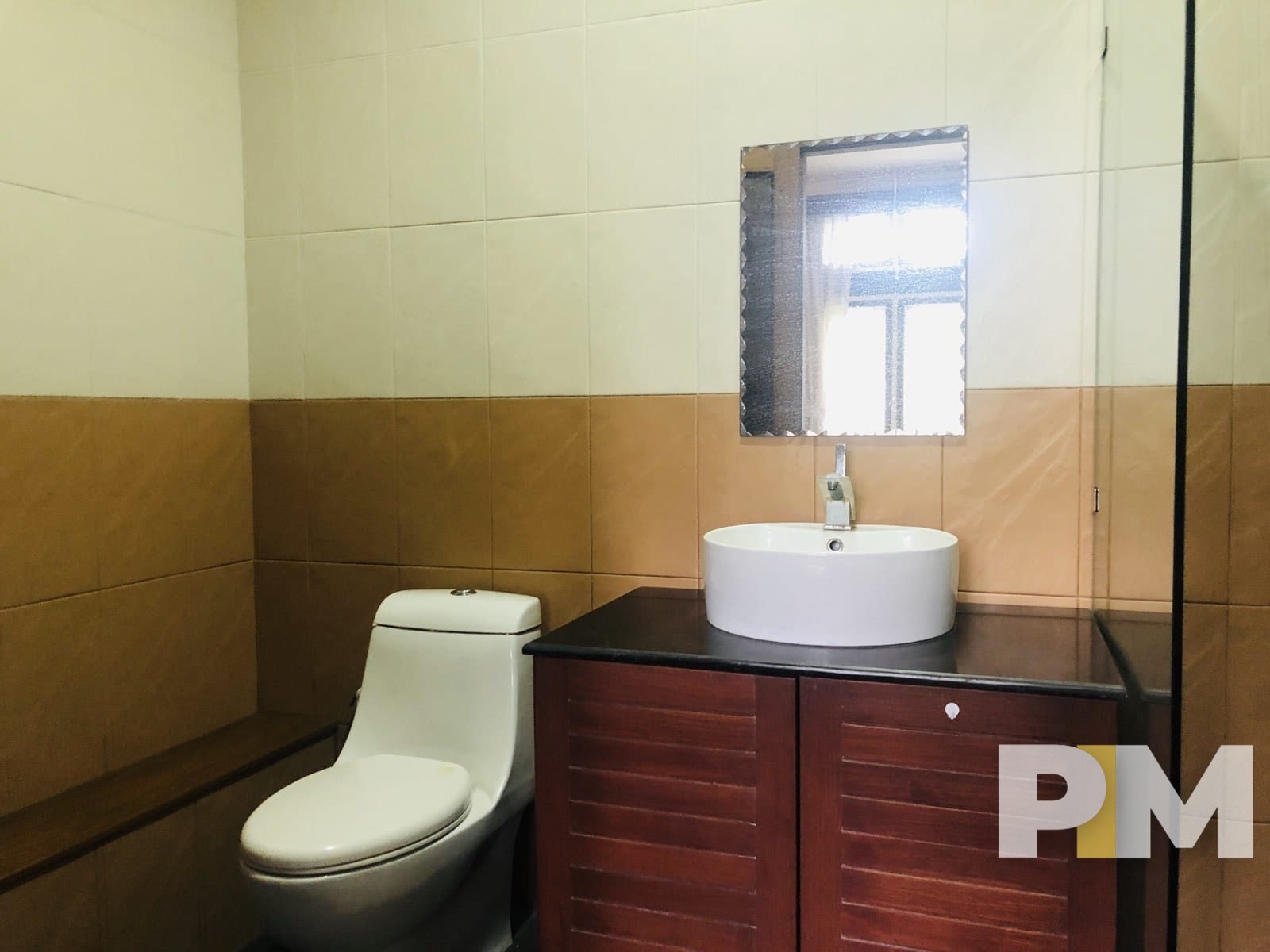 bathroom with mirror - property in Yangon