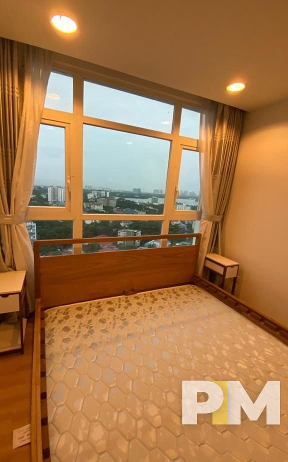 bedroom with bedside desk - properties in Yangon