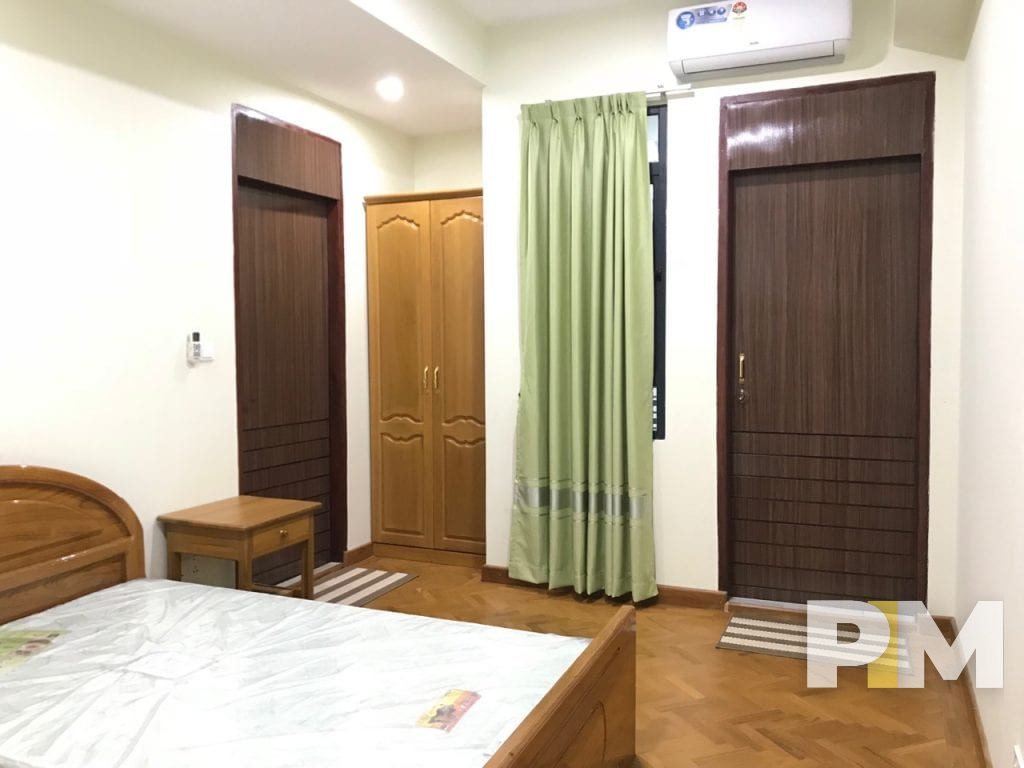 bedroom with bedside desk - property in Yangon