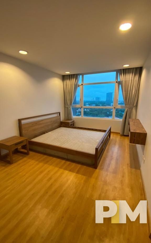 bedroom with bedside desk - property in Yangon