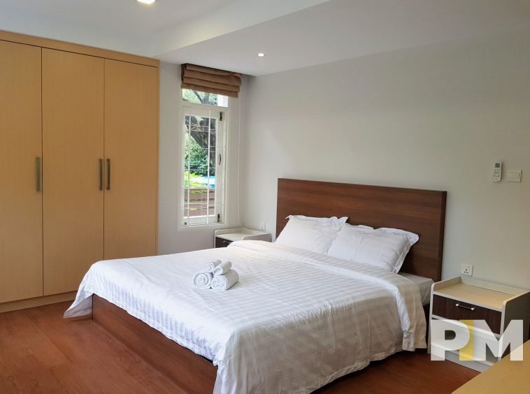 bedroom with bedside table - property in Yangon