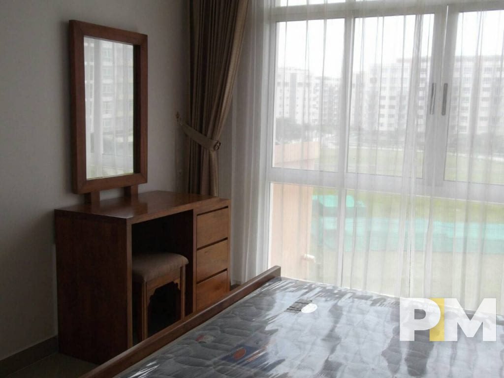 bedroom with vanity mirror - property in Yangon