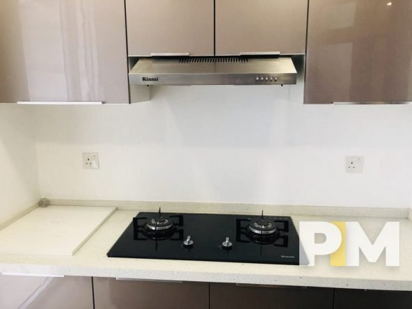 kitchen with stove and cooker hood - properties in Myanmar