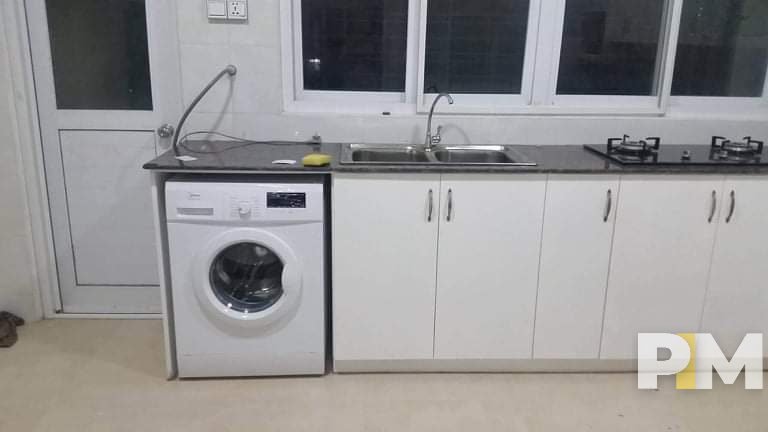 kitchen with washing machine - property in Yangon