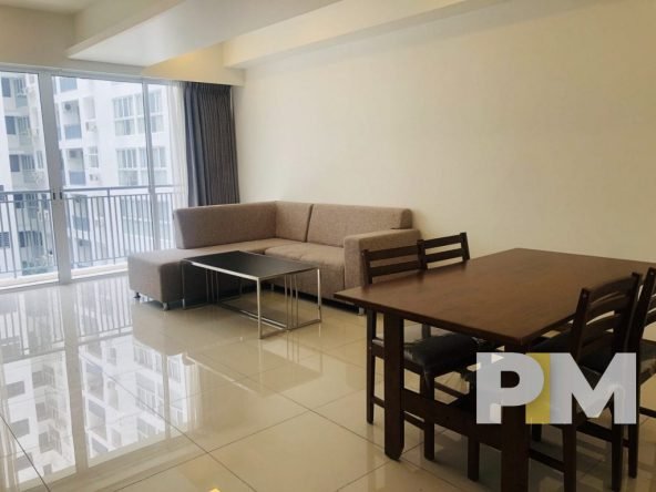 living room with sofa and dining tables - property in Yangon