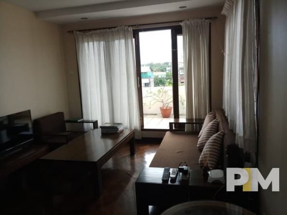 living room with table and seat - properties in Yangon