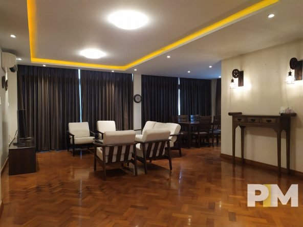 living room with wooden seats - property in Yangon
