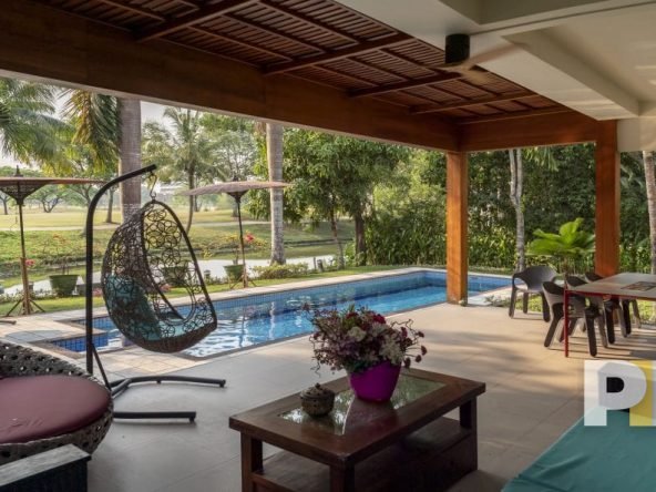swimming pool with outdoor seats - property in Yangon