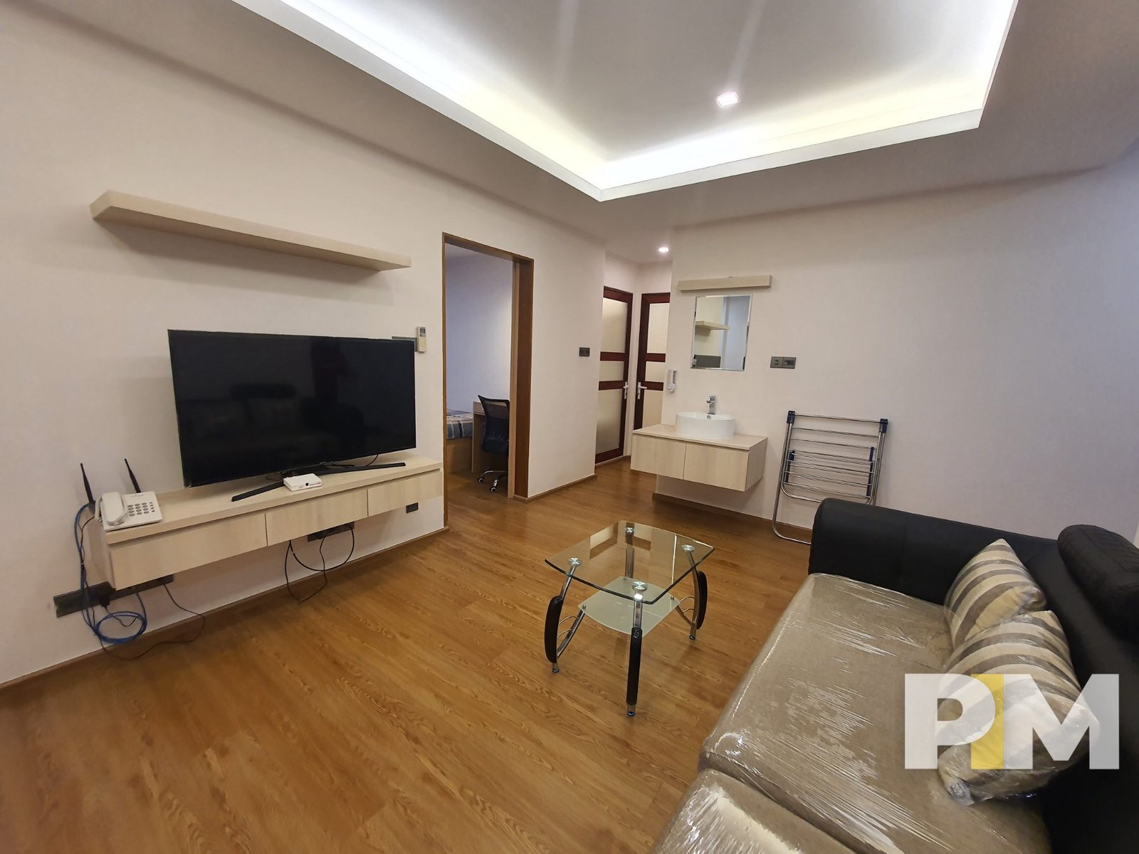 living room with TV - Serviced Apartments in Yangon