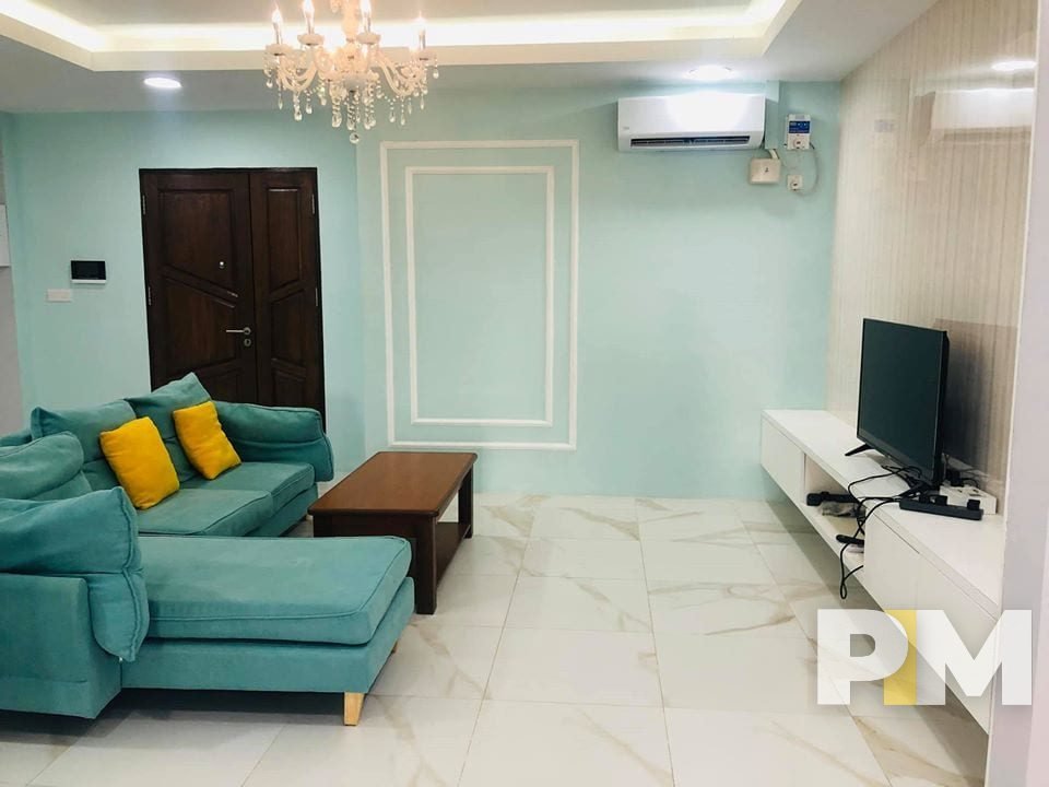 living room with hanging light - properties in Yangon
