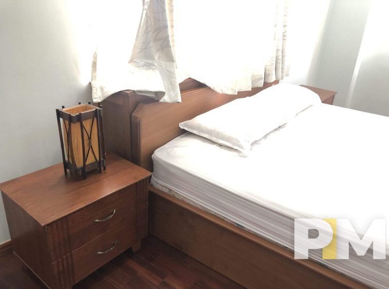 bedroom with bedside desk - properties in Yangon