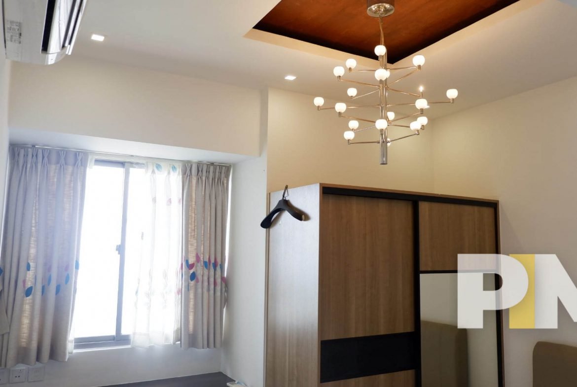 bedroom with hanging light - properties in Yangon