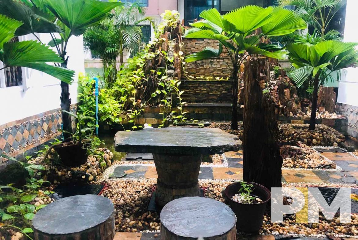 courtyard with wooden table and seats - Yangon Property