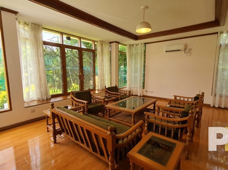 living room with wooden chair and coffee table - property in Yangon