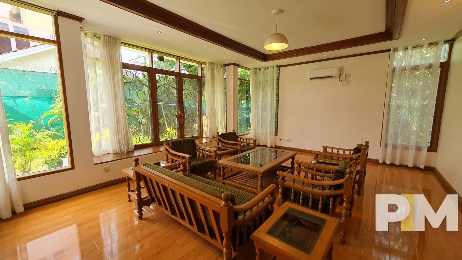 living room with wooden chair and coffee table - property in Yangon