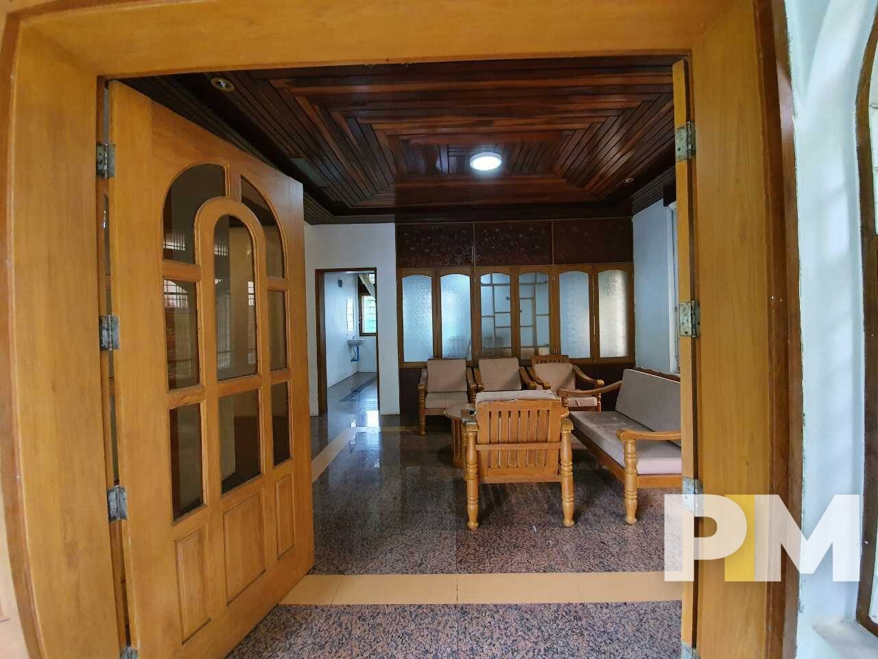 living room with wooden sofa set - Home Rental Myanmar