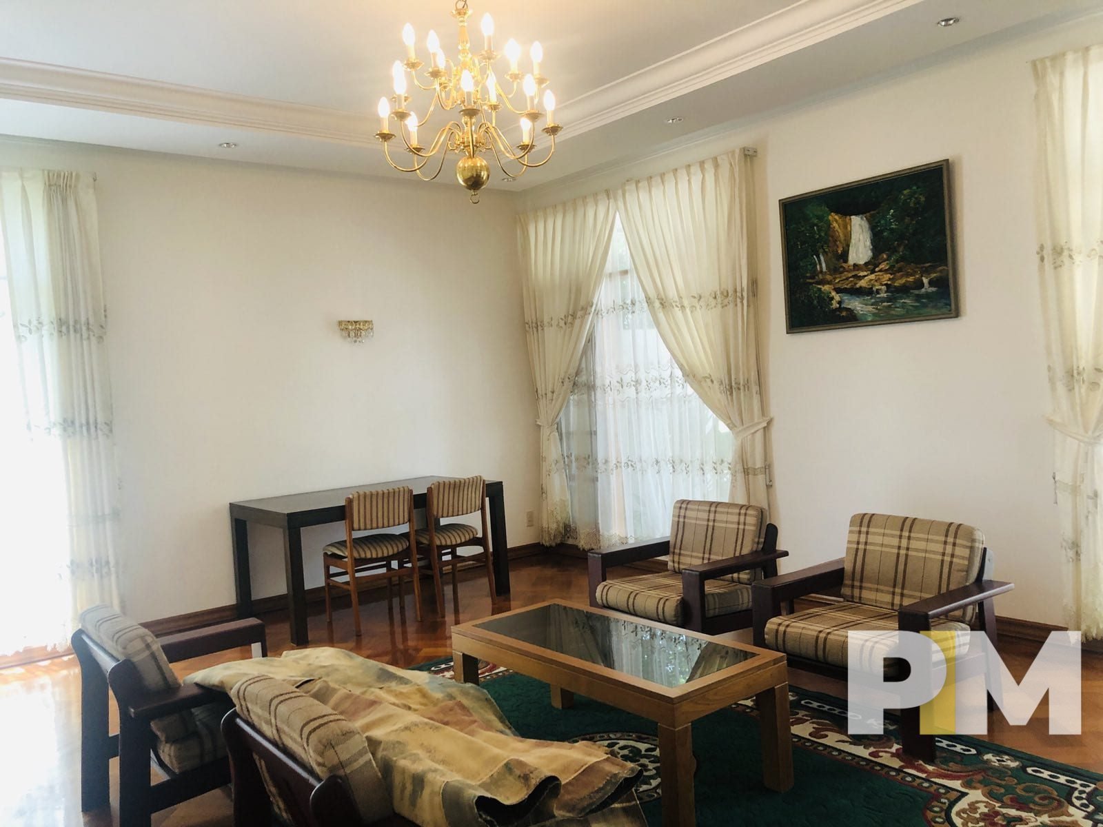 living room with wooden sofa set - properties in Yangon