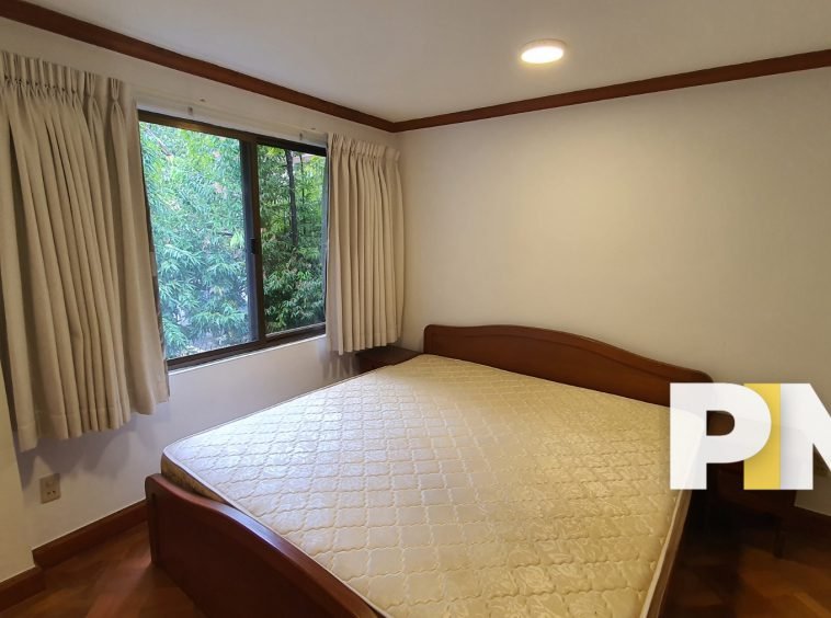 Bedroom with curtains - Property in Myanmar